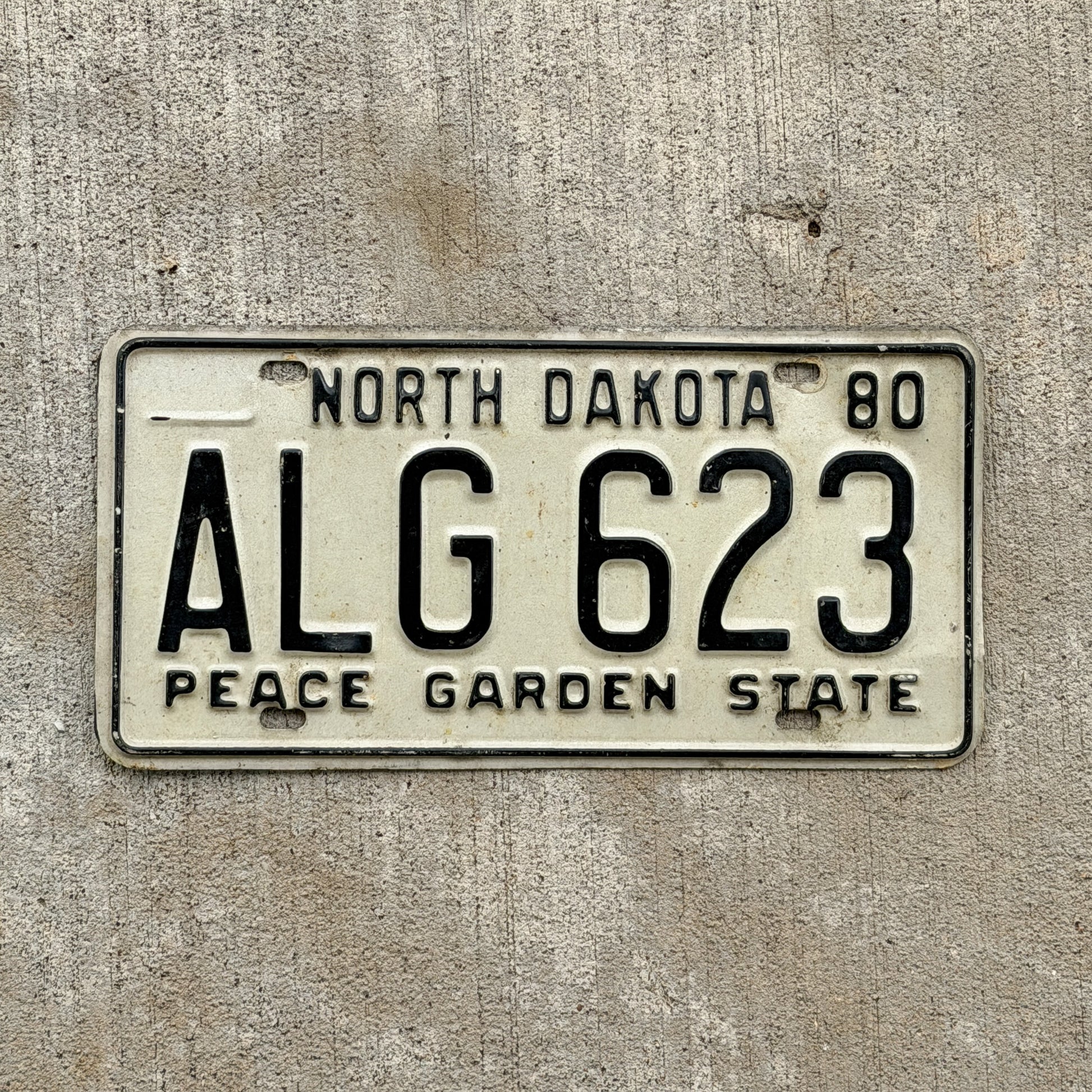 Photo of a 1980 North Dakota License Plate Auto Tag Garage Decor Vintage ALG 623 with original patina