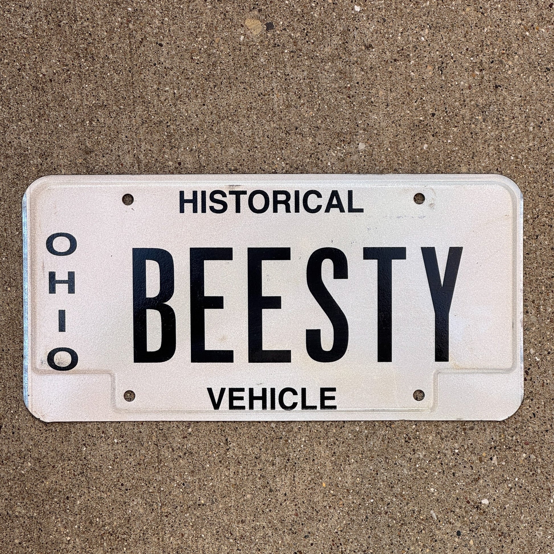 Photo of a 1980 Ohio Historical Vehicle Vanity License Plate Auto Tag Garage Decor Vintage Bees Besty BEESTY with original patina