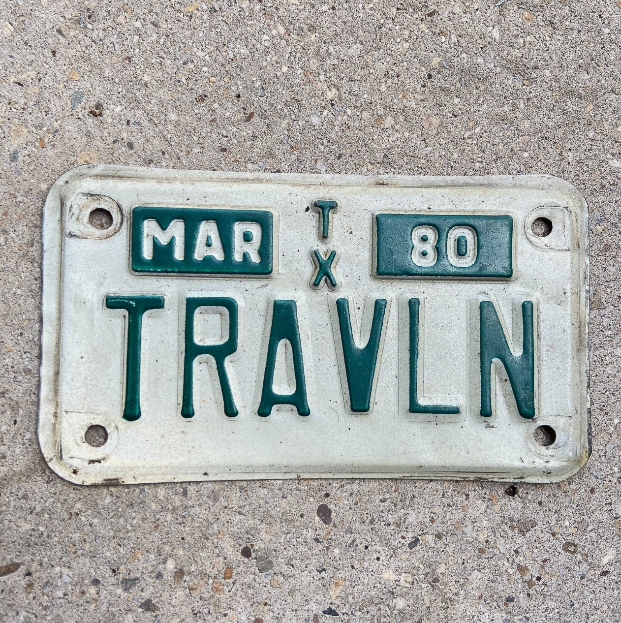 Photo of a 1980 Texas Motorcycle Vanity License Plate Auto Tag Garage Decor Vintage Traveler Gift TRAVLN with original patina