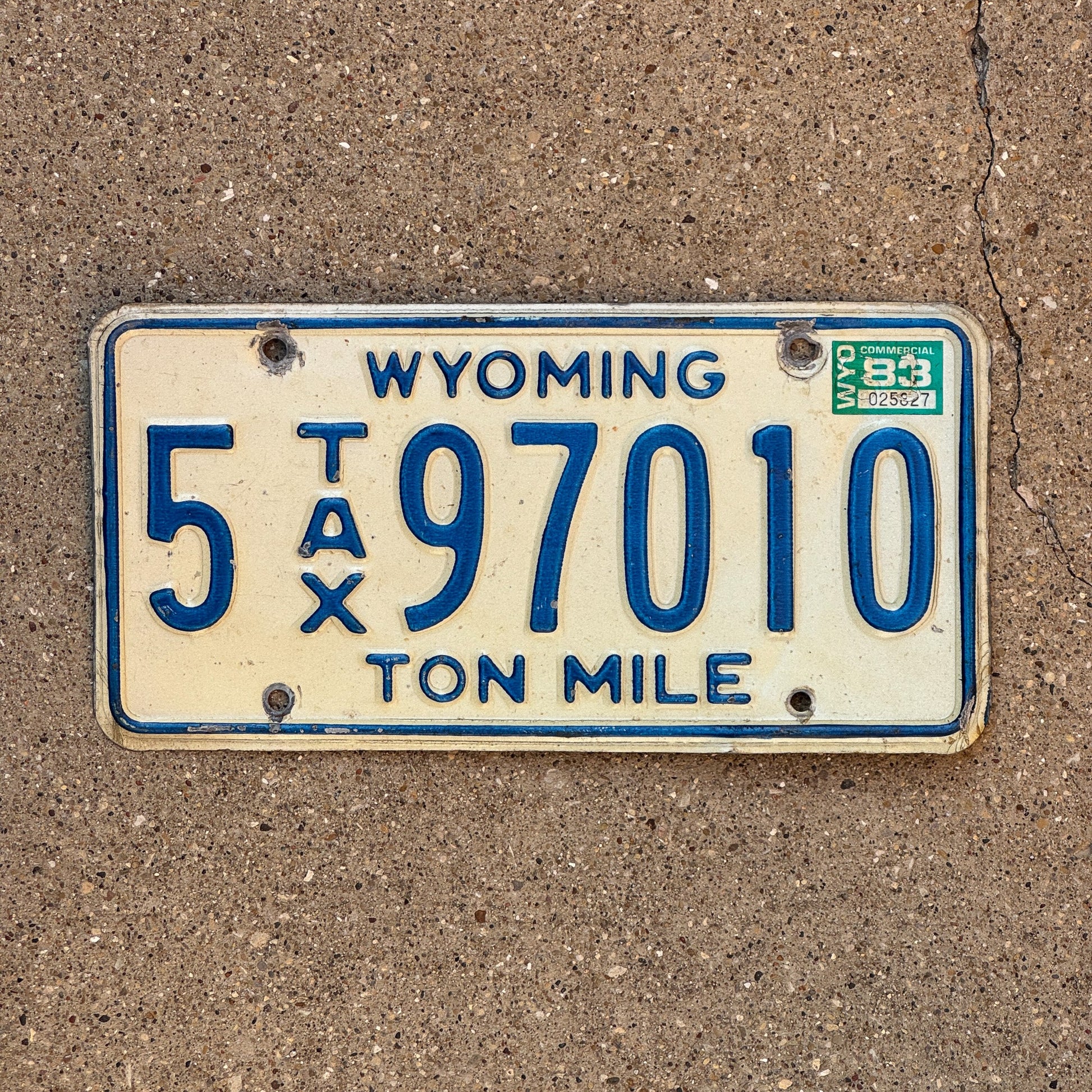 Photo of a 1981 1983 Wyoming Ton Mile Tax License Plate Auto Tag Garage Decor Vintage 5 97010