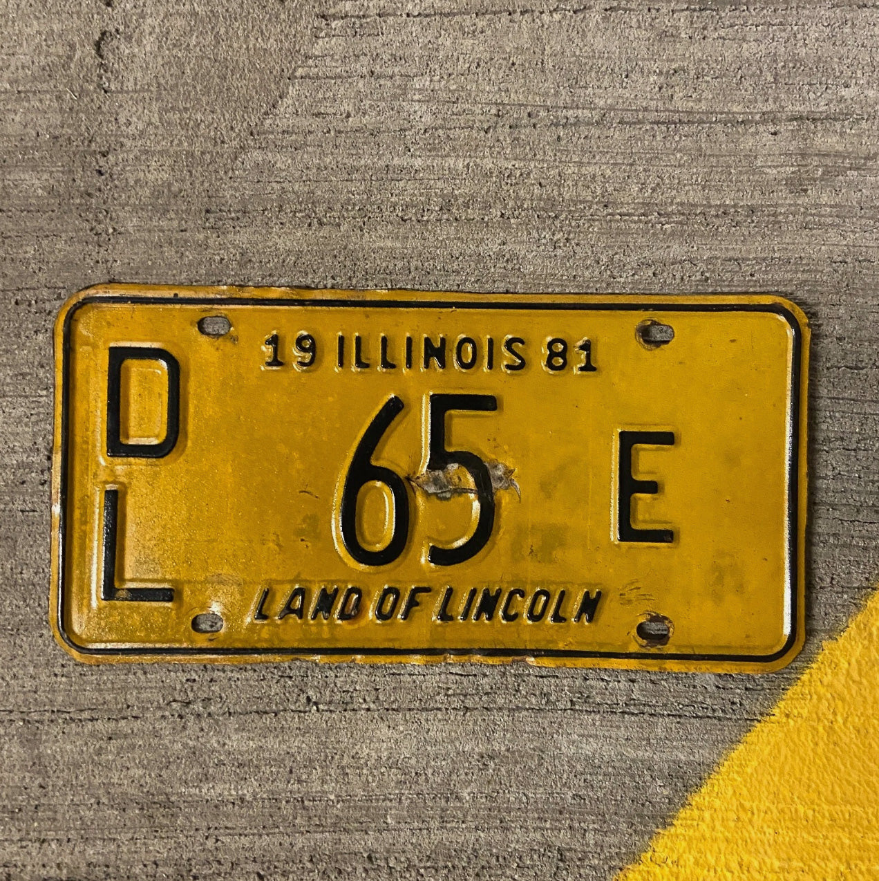 Photo of a 1981 Illinois Dealer License Plate Auto Tag Garage Decor Vintage 65 E with original patina