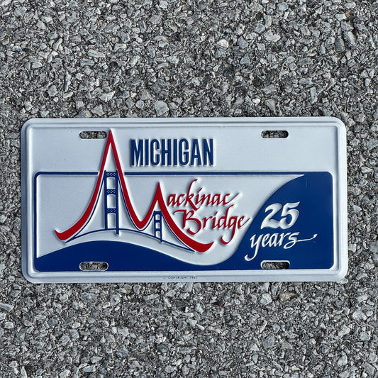 Photo of a 1982 Michigan Booster License Plate Auto Tag Garage Decor Vintage Mackinac Bridge 25th Anniversary