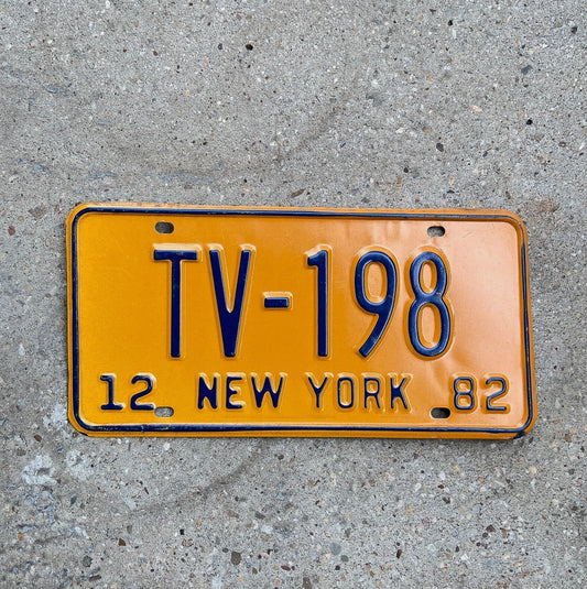 Photo of a 1982 New York Television License Plate Auto Tag Garage Decor Vintage TV 198 with original patina