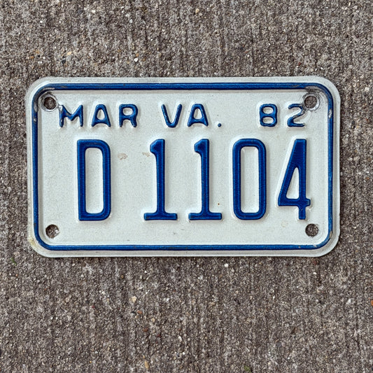 Photo of a 1982 Virginia Motorcycle License Plate Auto Tag Garage Decor Vintage Dealer D 1104 with original patina