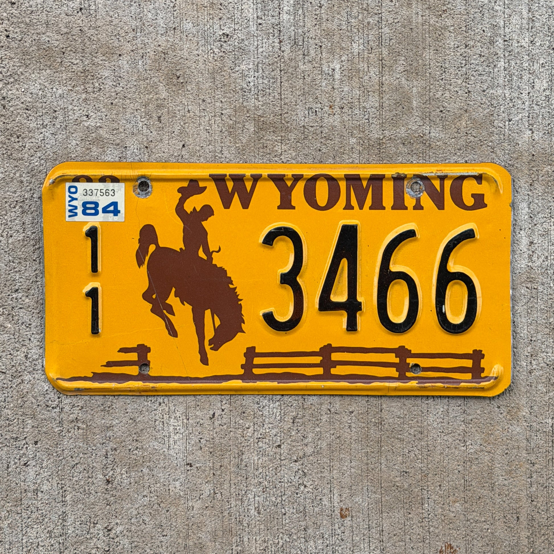 Photo of a 1983 1984 Wyoming License Plate Auto Tag Garage Decor Vintage Cowboy Rodeo 11 3466 with original patina