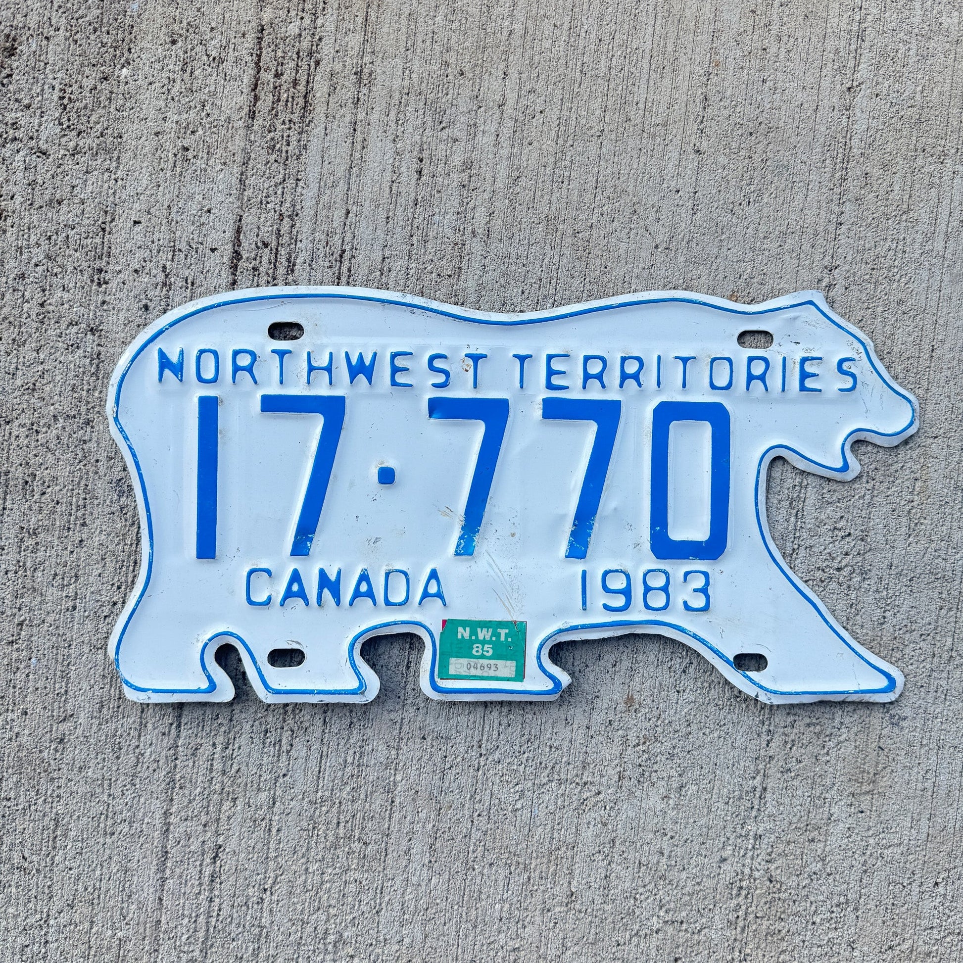 Photo of a 1983 1985 Northwest Territories License Plate Auto Tag Garage Decor Vintage Polar Bear Lucky 7s 17 770 with original patina