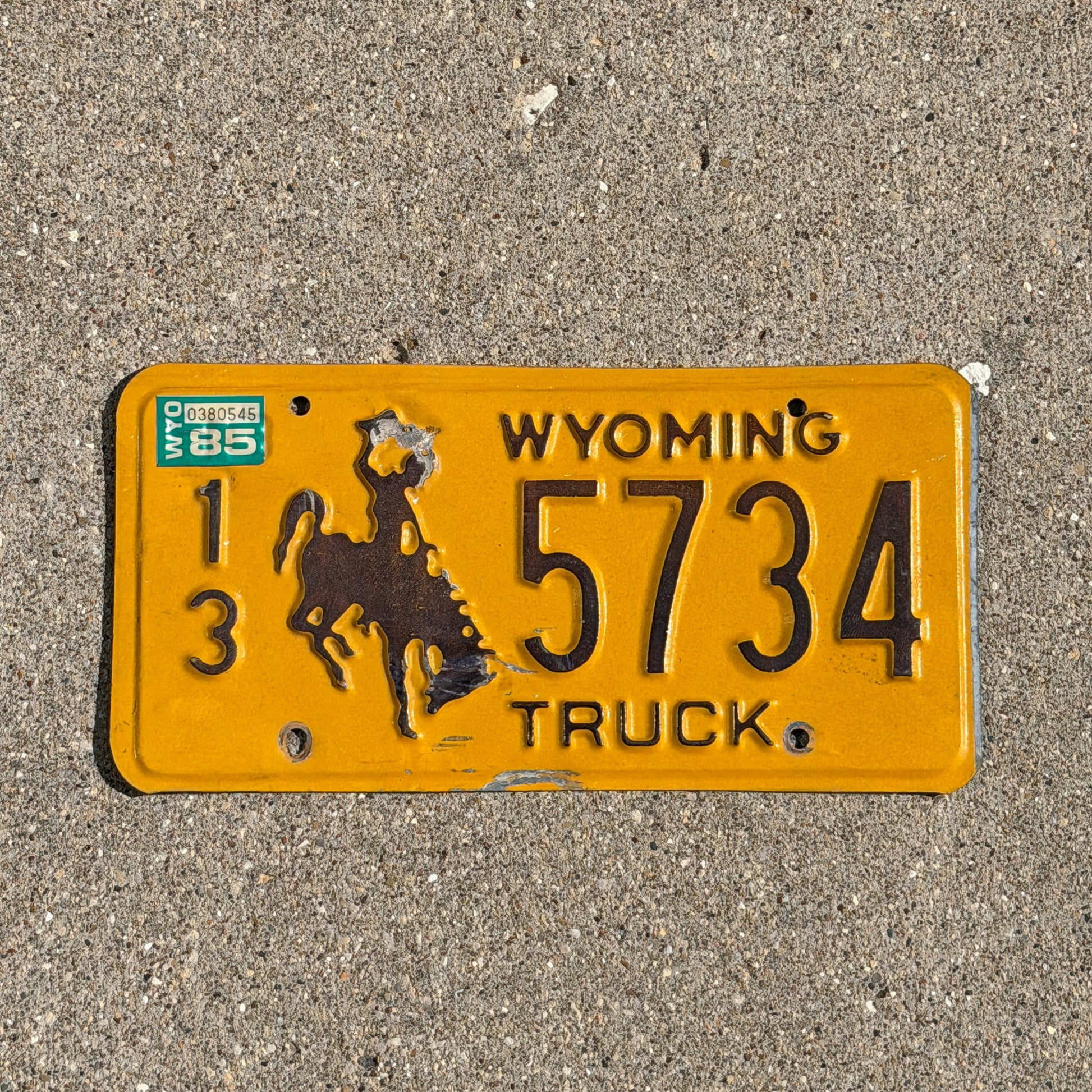 Photo of a 1983 1985 Wyoming Truck License Plate Auto Tag 1 Vintage Cowboy Rodeo 13 5734 with original patina