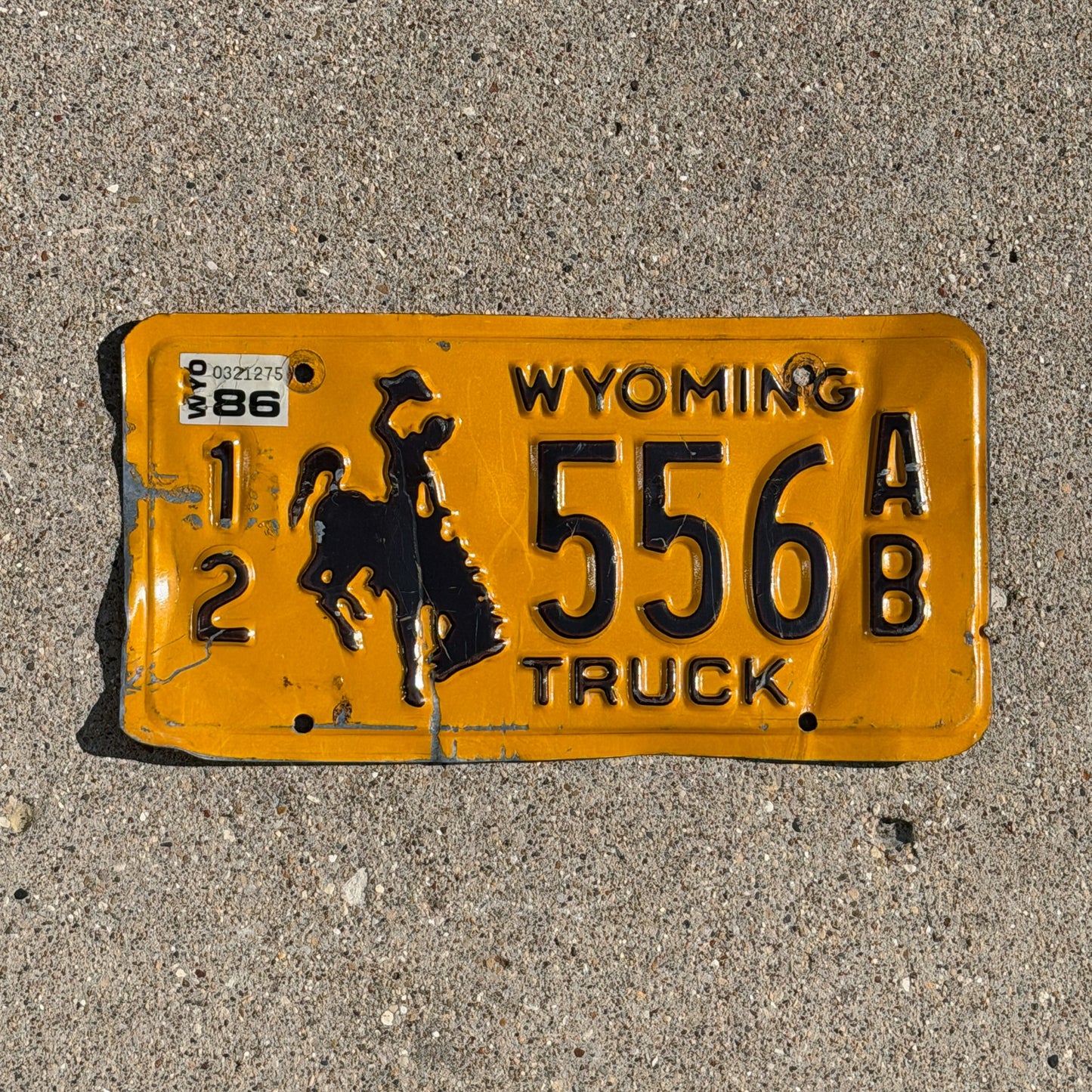 Photo of a 1983 1986 Wyoming Truck License Plate Auto Tag Garage Decor Vintage Cowboy Rodeo 12 556 AB with original patina
