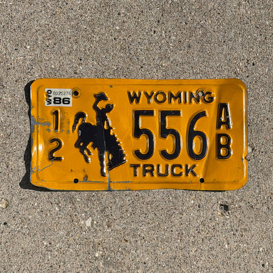 Photo of a 1983 1986 Wyoming Truck License Plate Auto Tag Garage Decor Vintage Cowboy Rodeo 12 556 AB with original patina