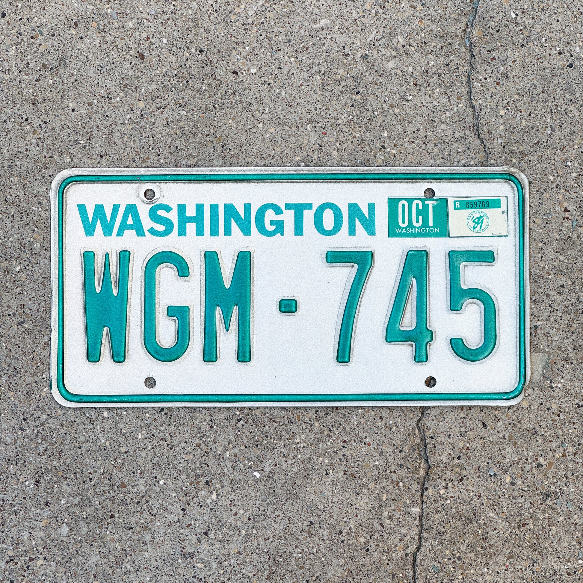 Photo of a 1983 1989 Washington License Plate Auto Tag Garage Decor Vintage DMV Clear Number WGM 745 with original patina