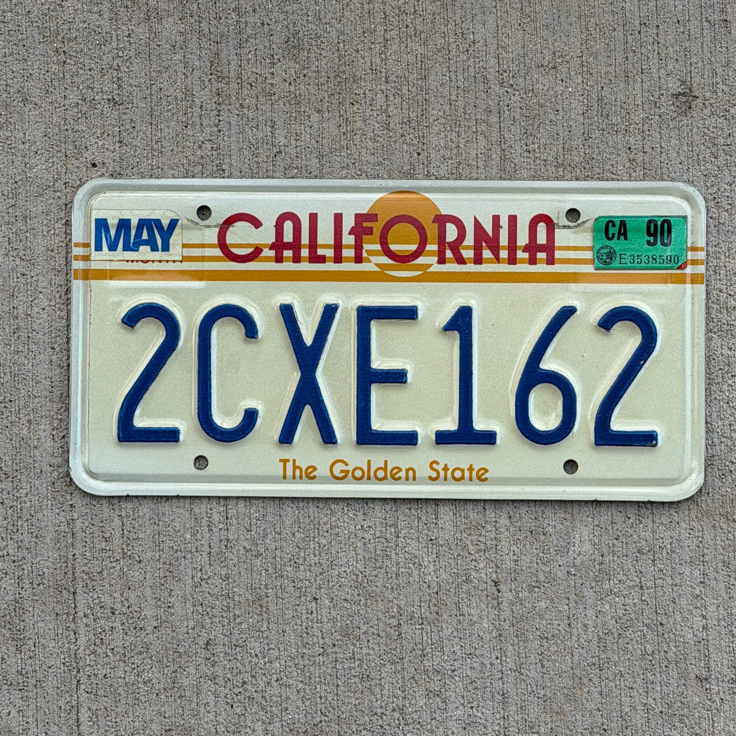 Photo of a 1983 1990 California License Plate Auto Tag Garage Decor Vintage Golden State Sun Base 2 CXE 162 with original patina