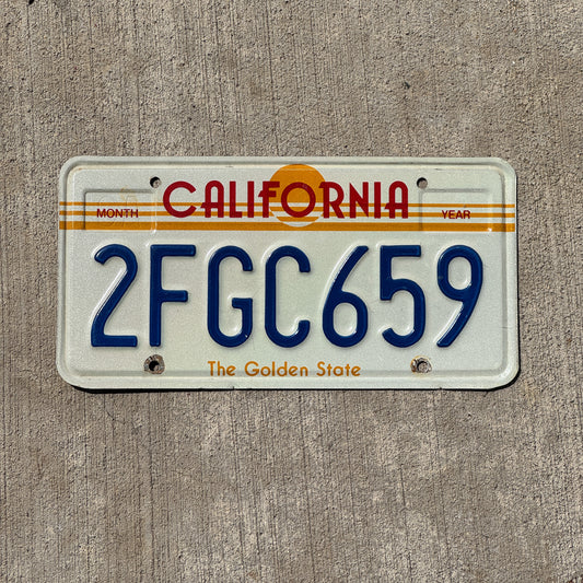 Photo of a 1983 California License Plate Auto Tag Garage Decor Vintage Golden State Sun Base 2 FGC 659 with original patina