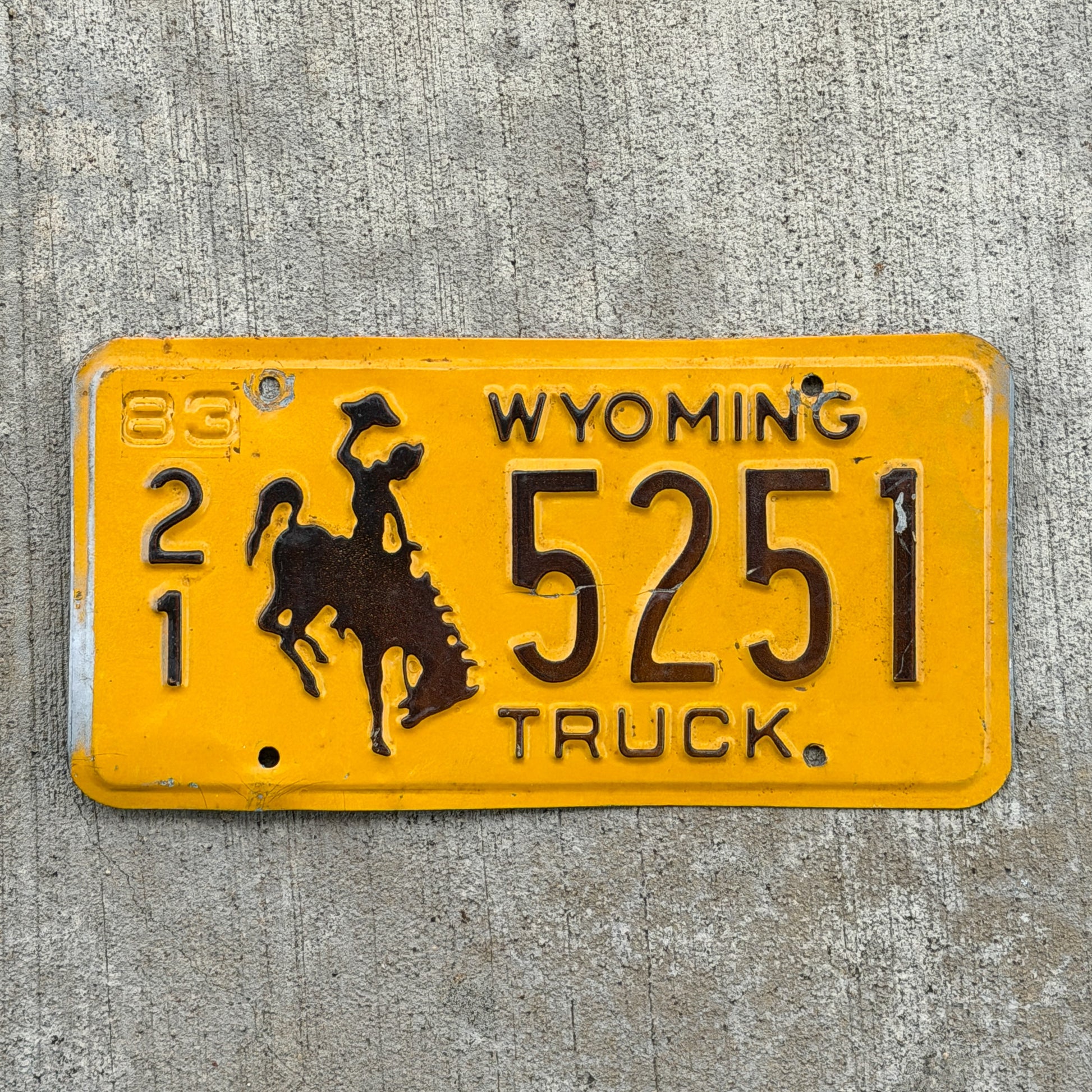 Photo of a 1983 Wyoming Truck License Plate Auto Tag Garage Decor Vintage Cowboy Rodeo 21 5251 with original patina