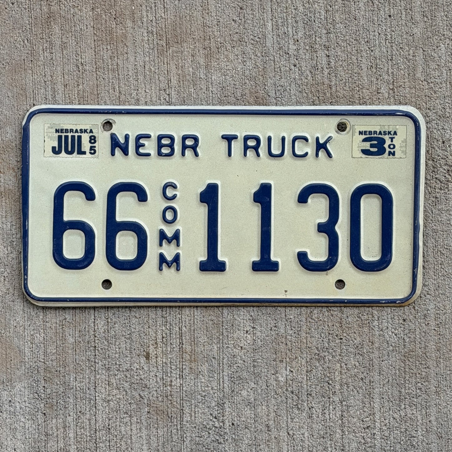 Photo of a 1984 1985 Nebraska Commercial License Plate Auto Tag Garage Decor Vintage 66 1130 with original patina