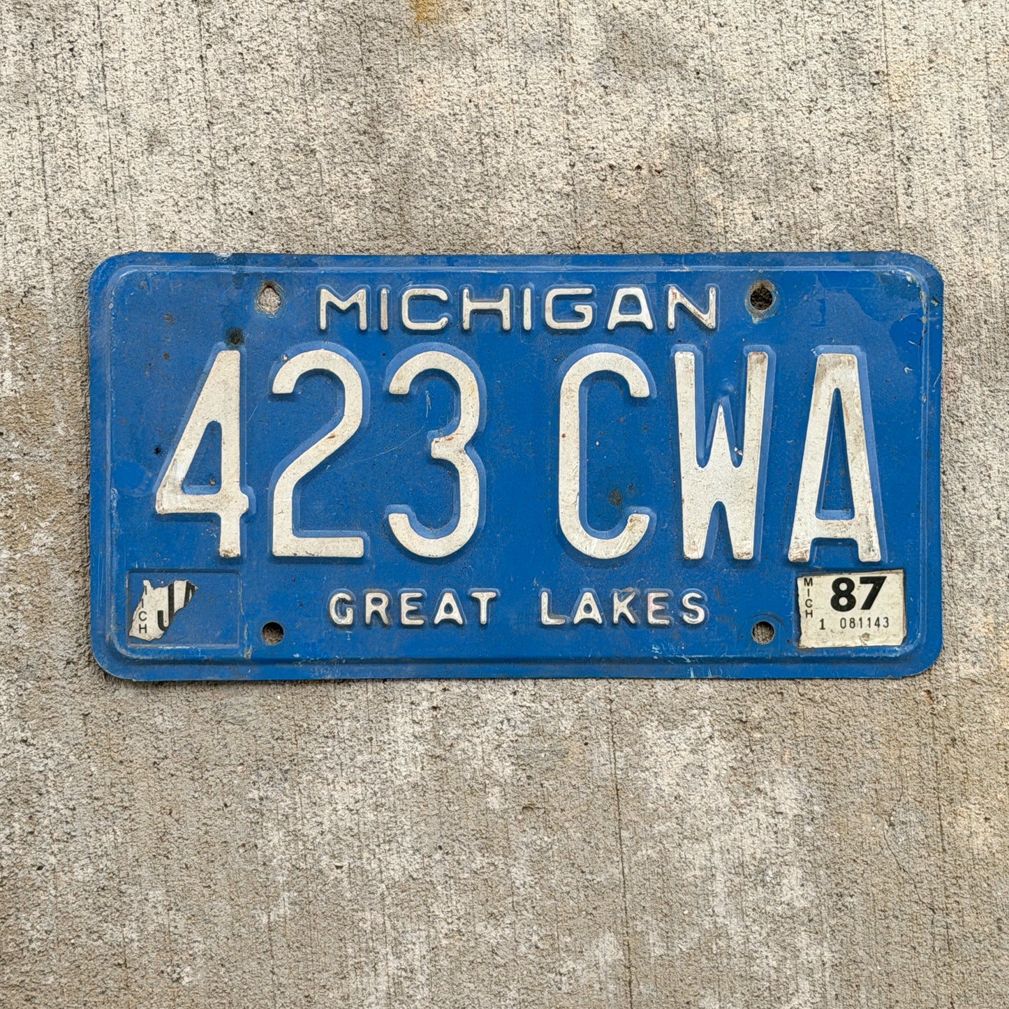 Photo of a 1984 1987 Michigan License Plate Auto Tag Garage Decor Vintage 423 CWA with original patina