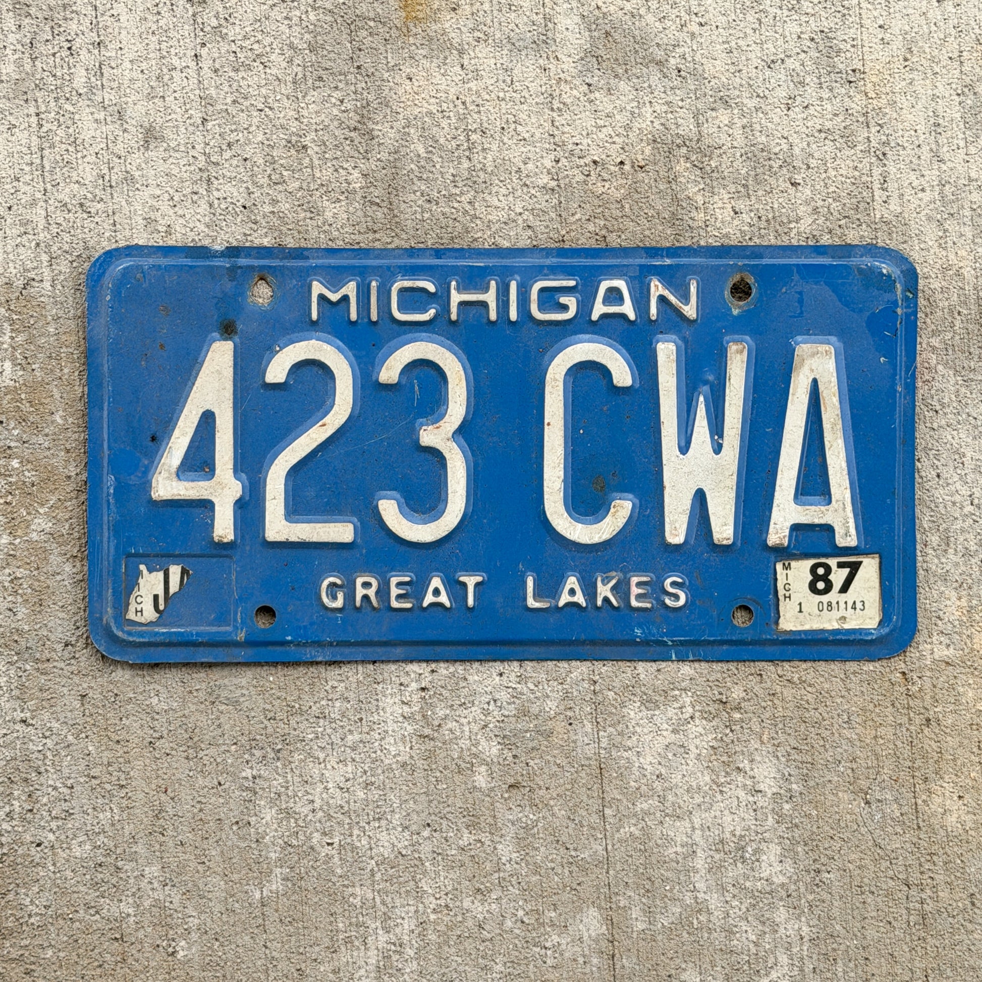 Photo of a 1984 1987 Michigan License Plate Auto Tag Garage Decor Vintage 423 CWA with original patina