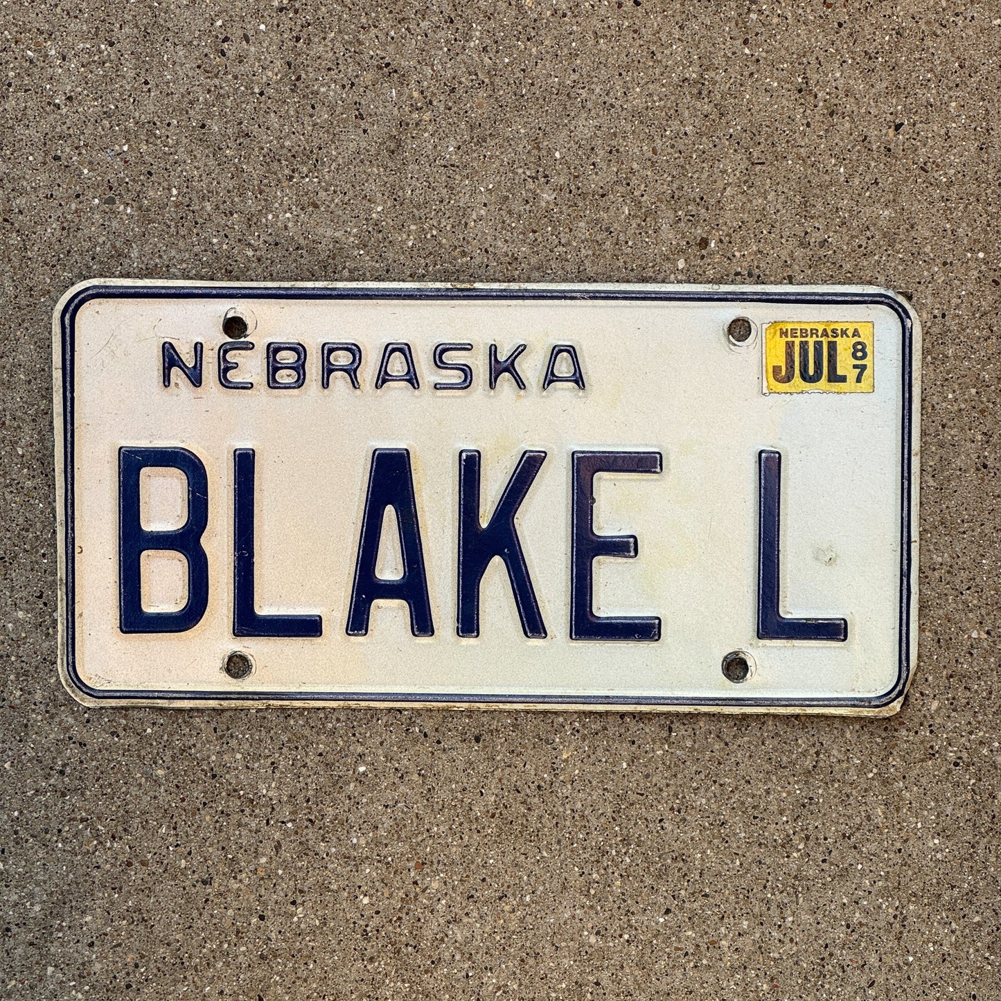 Photo of a 1984 1987 Nebraska Vanity License Plate Auto Tag Garage Decor Vintage Name BLAKE L with original patina