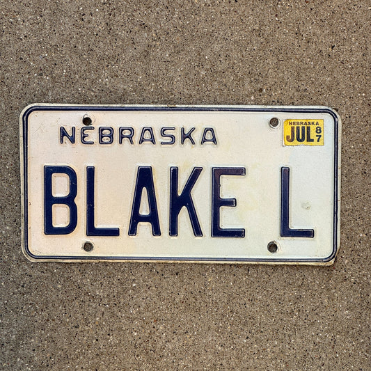 Photo of a 1984 1987 Nebraska Vanity License Plate Auto Tag Garage Decor Vintage Name BLAKE L with original patina