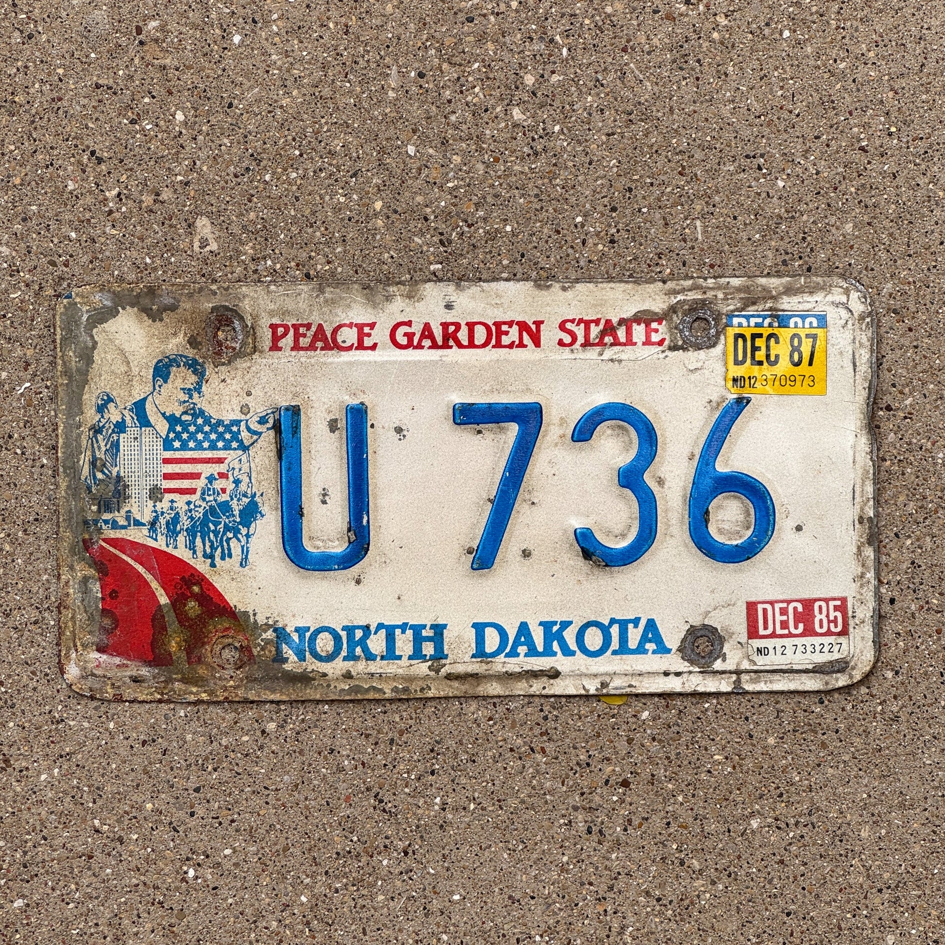 Photo of a 1984 1987 North Dakota License Plate Auto Tag Garage Decor Vintage Reserved Series U 736 with original patina