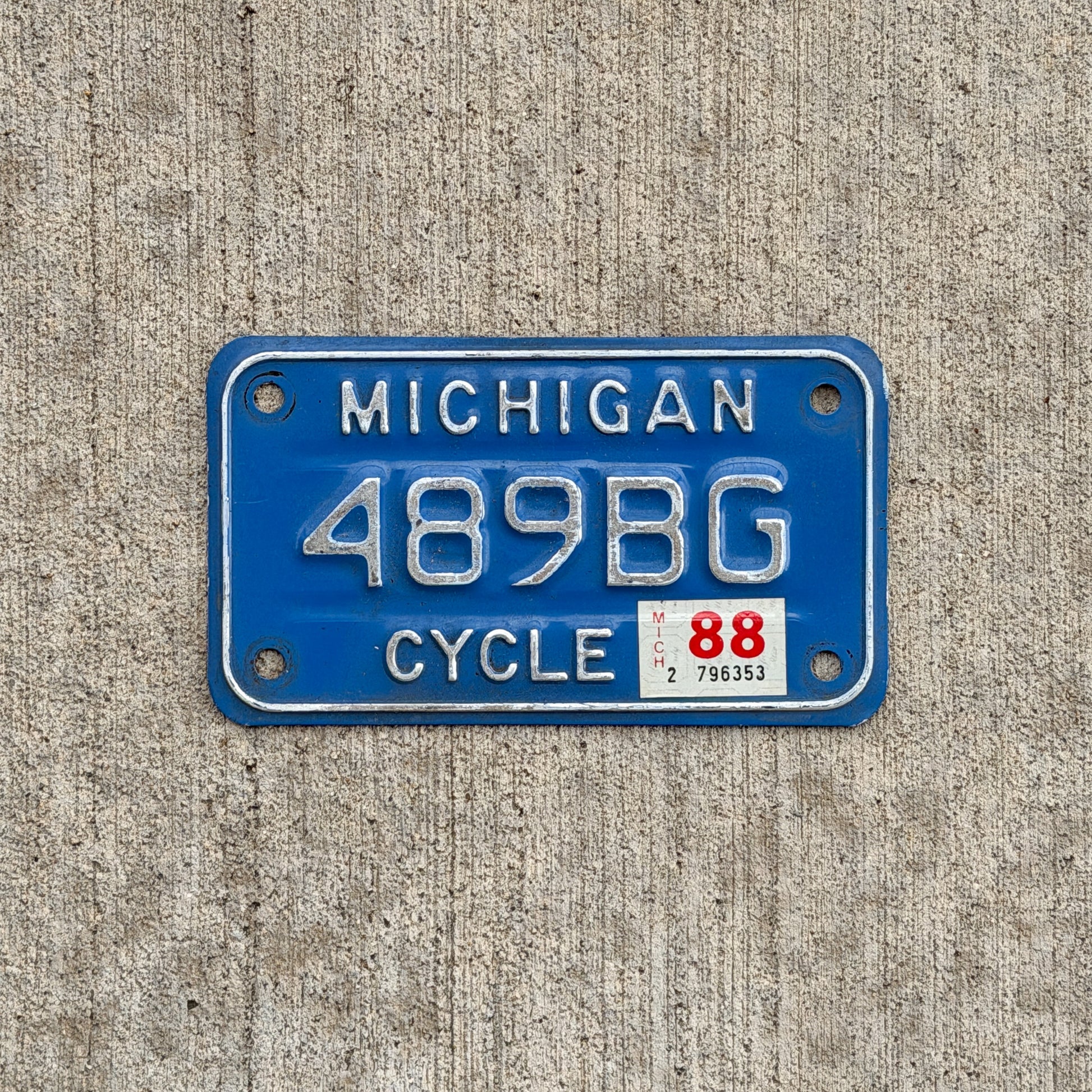 Photo of a 1984 1988 Michigan Motorcycle License Plate Auto Tag Garage Decor Vintage 489 BG with original patina