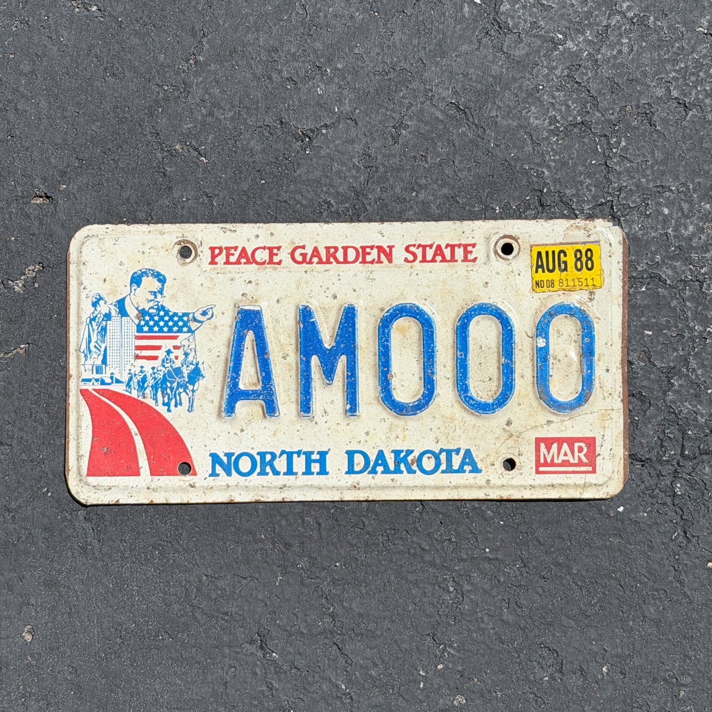 Photo of a 1984 1988 North Dakota License Plate Auto Tag Garage Decor Vintage Repeat Repeating AM 000 with original patina