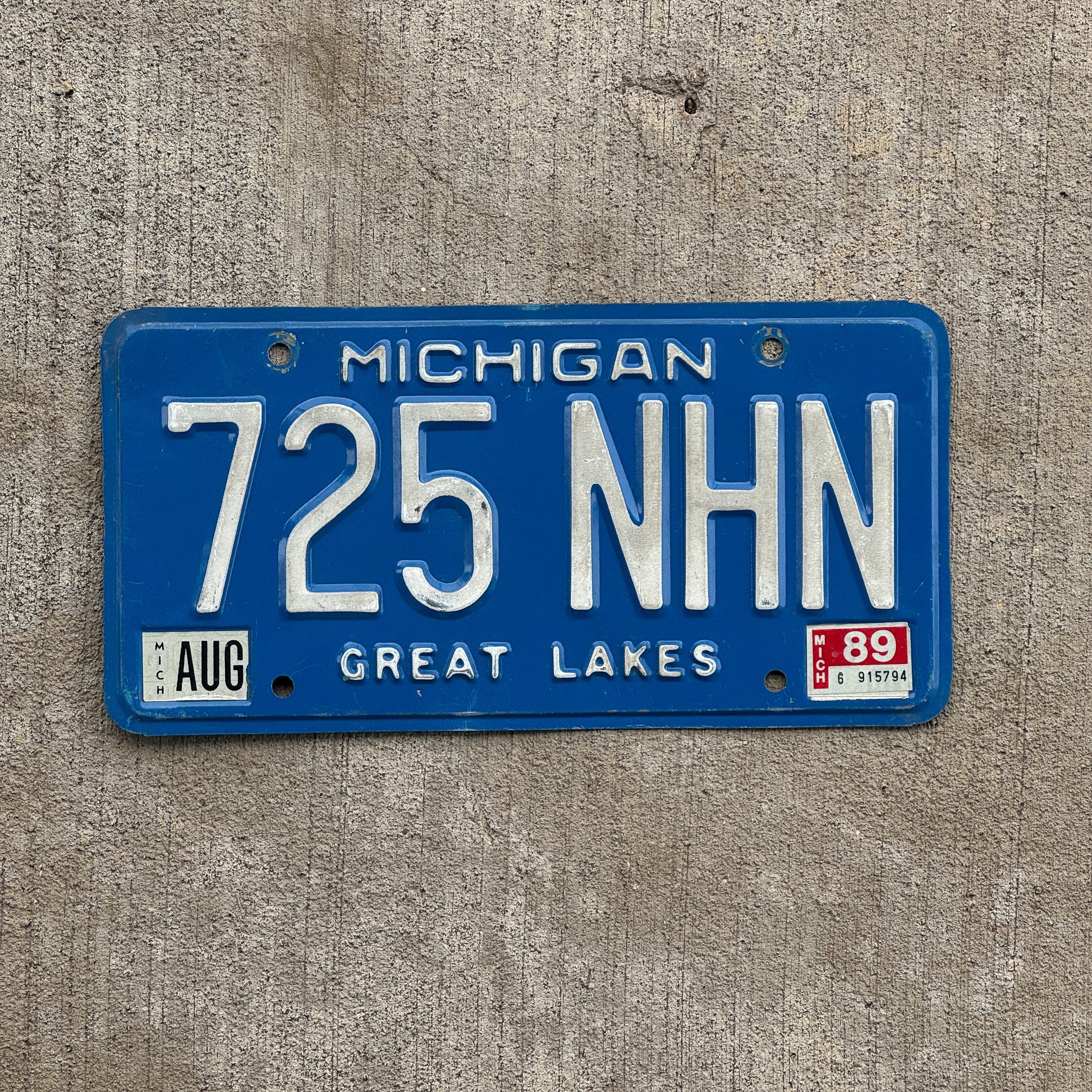 Photo of a 1984 1989 Michigan License Plate Auto Tag Garage Decor Vintage 725 NHN with original patina