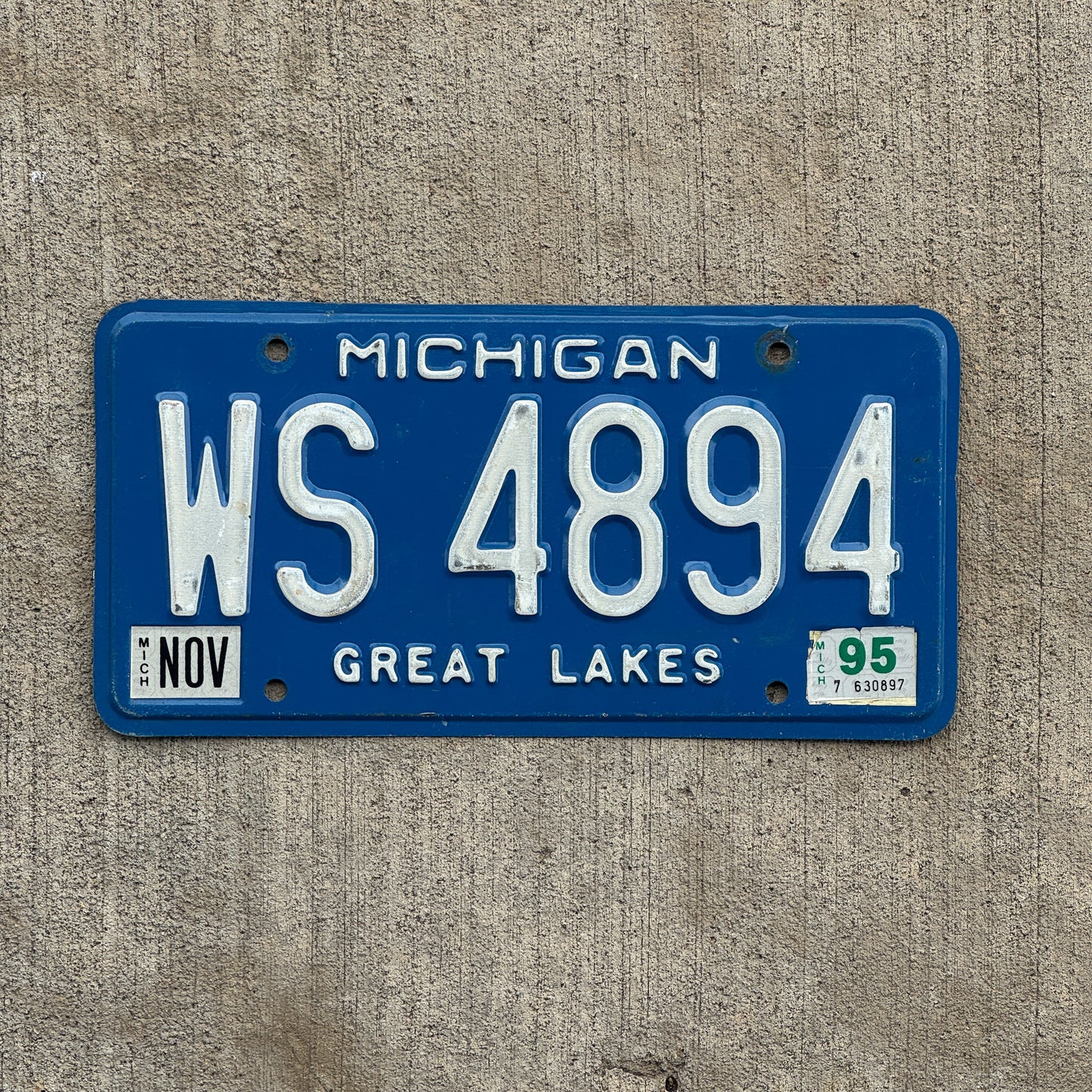 Photo of a 1984 1995 Michigan Commercial License Plate Auto Tag Garage Decor Vintage WS 4894 with original patina