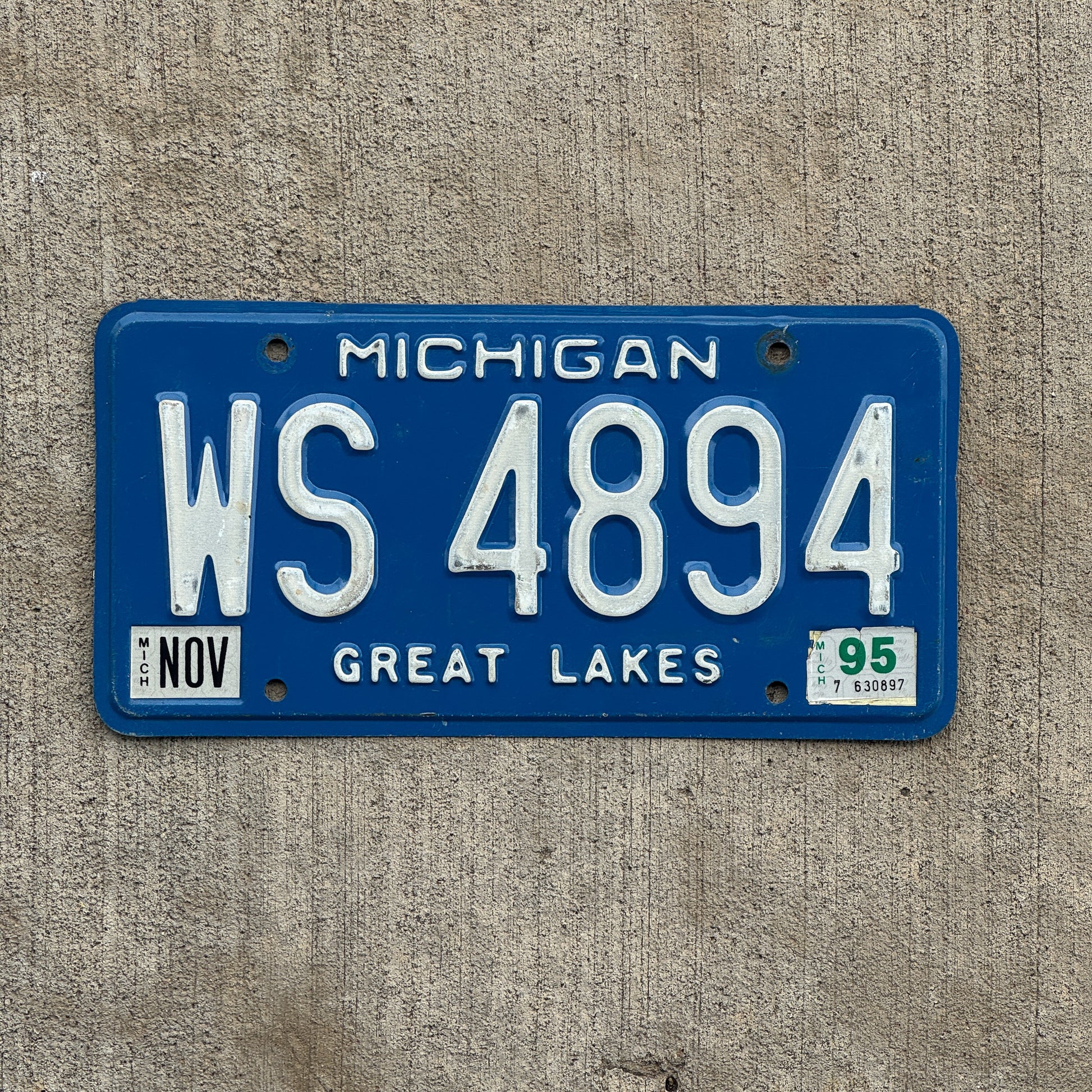 Photo of a 1984 1995 Michigan Commercial License Plate Auto Tag Garage Decor Vintage WS 4894 with original patina