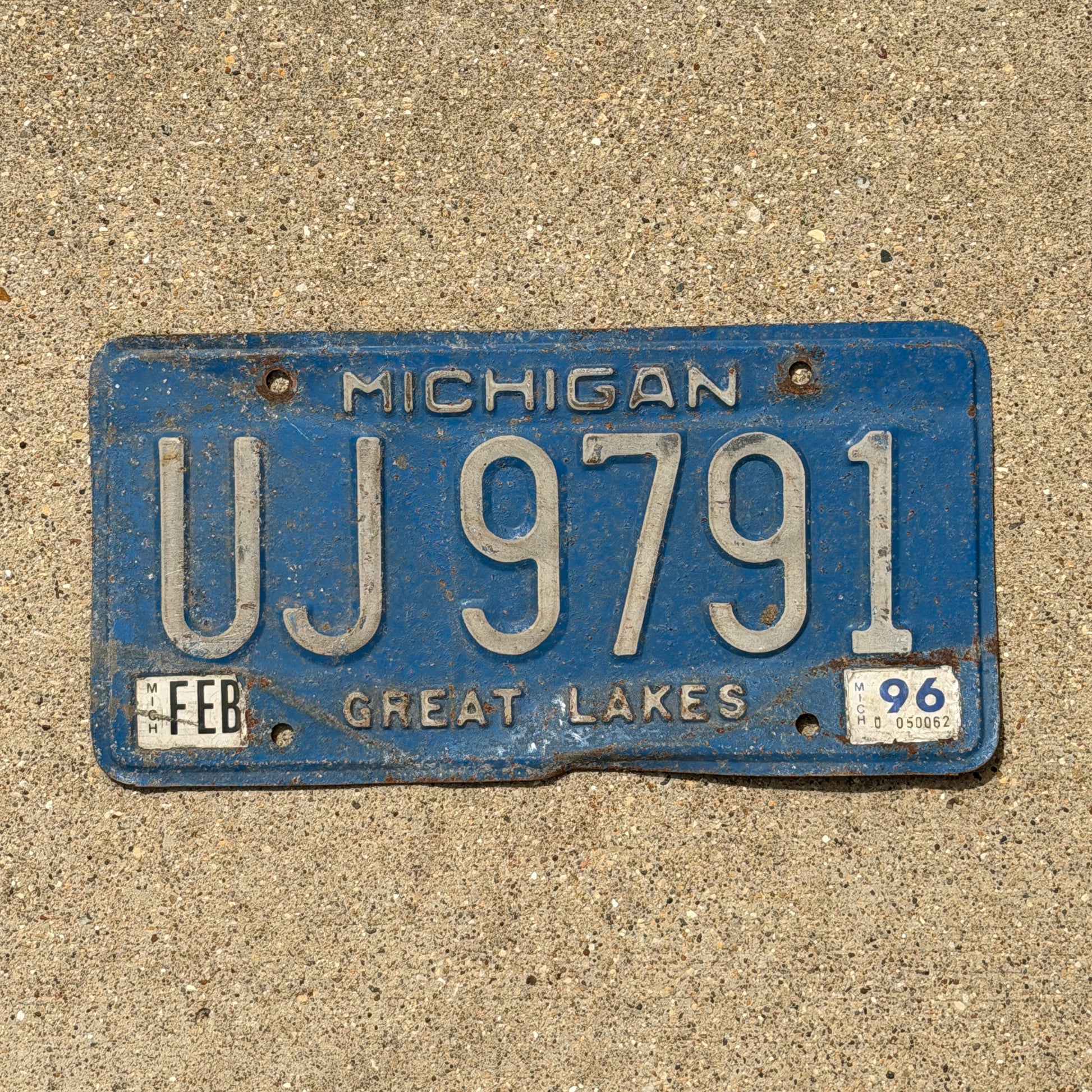 Photo of a 1984 1996 Michigan Commercial License Plate Auto Tag Garage Decor Vintage UJ 9791 with original patina