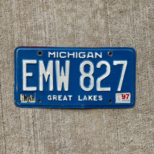 Photo of a 1984 1997 Michigan License Plate Auto Tag Garage Decor Vintage EMW 827 with original patina