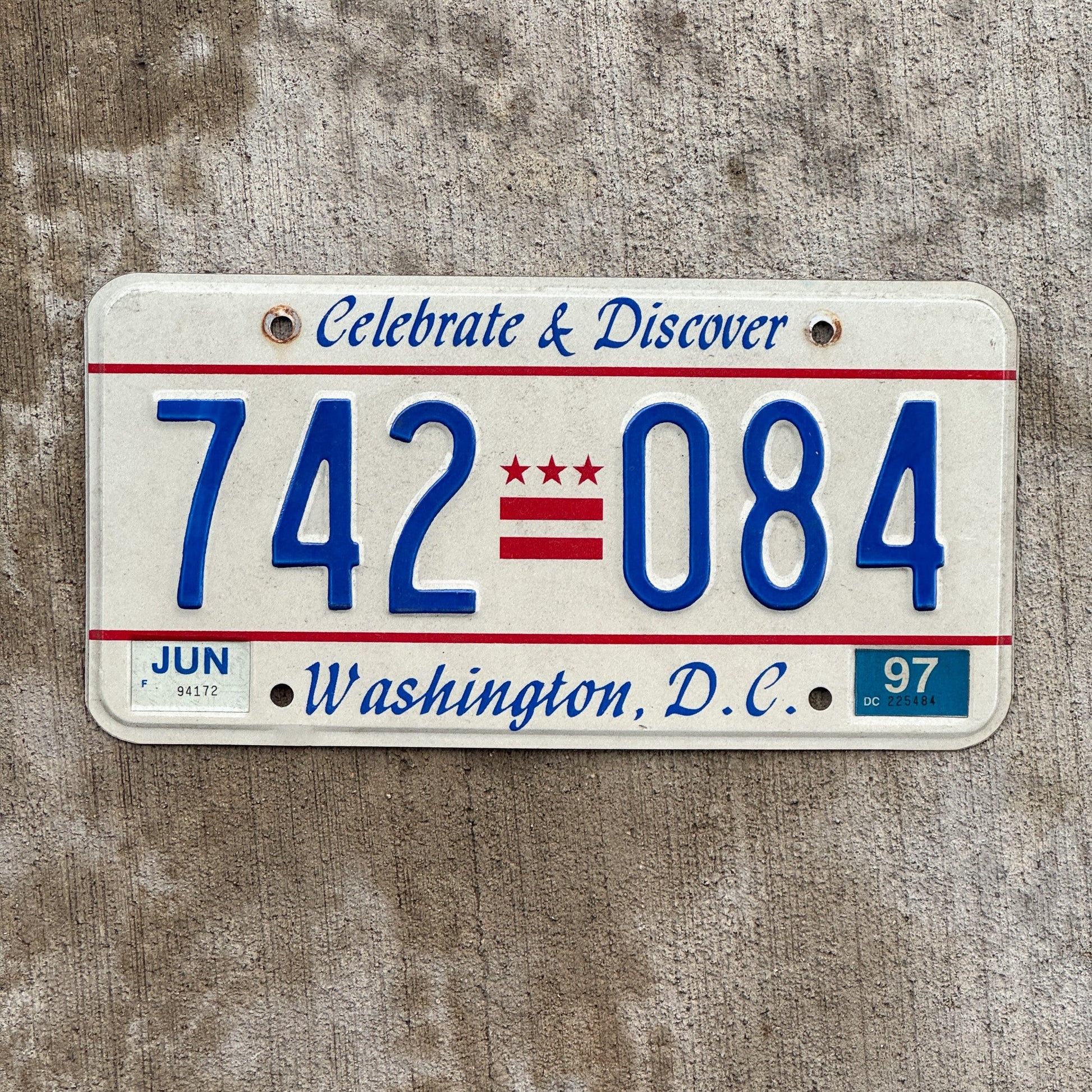 Photo of a 1984 1997 Washington DC License Plate Auto Tag Garage Decor Vintage Celebrate and Discover 742 084 with original patina