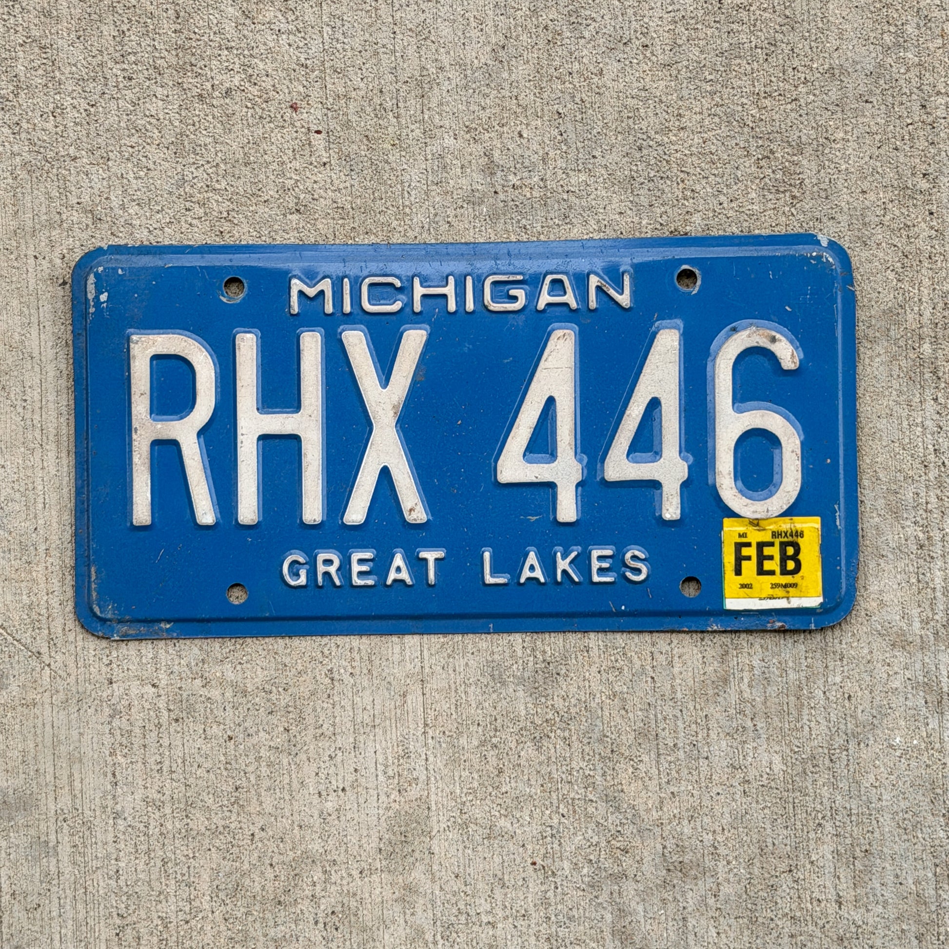Photo of a 1984 2002 Michigan License Plate Auto Tag Garage Decor Vintage RHX 446 with original patina