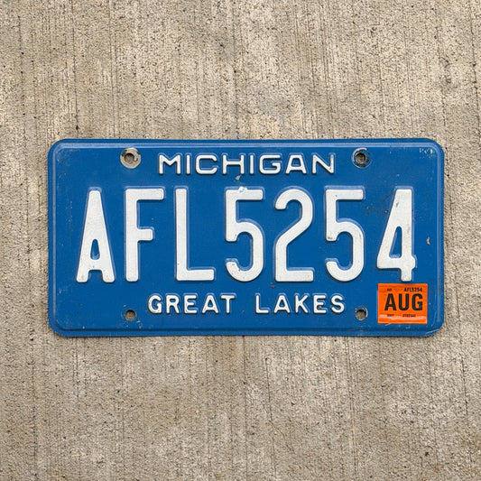 Photo of a 1984 2007 Michigan License Plate Auto Tag Garage Decor Vintage AFL 5254 with original patina