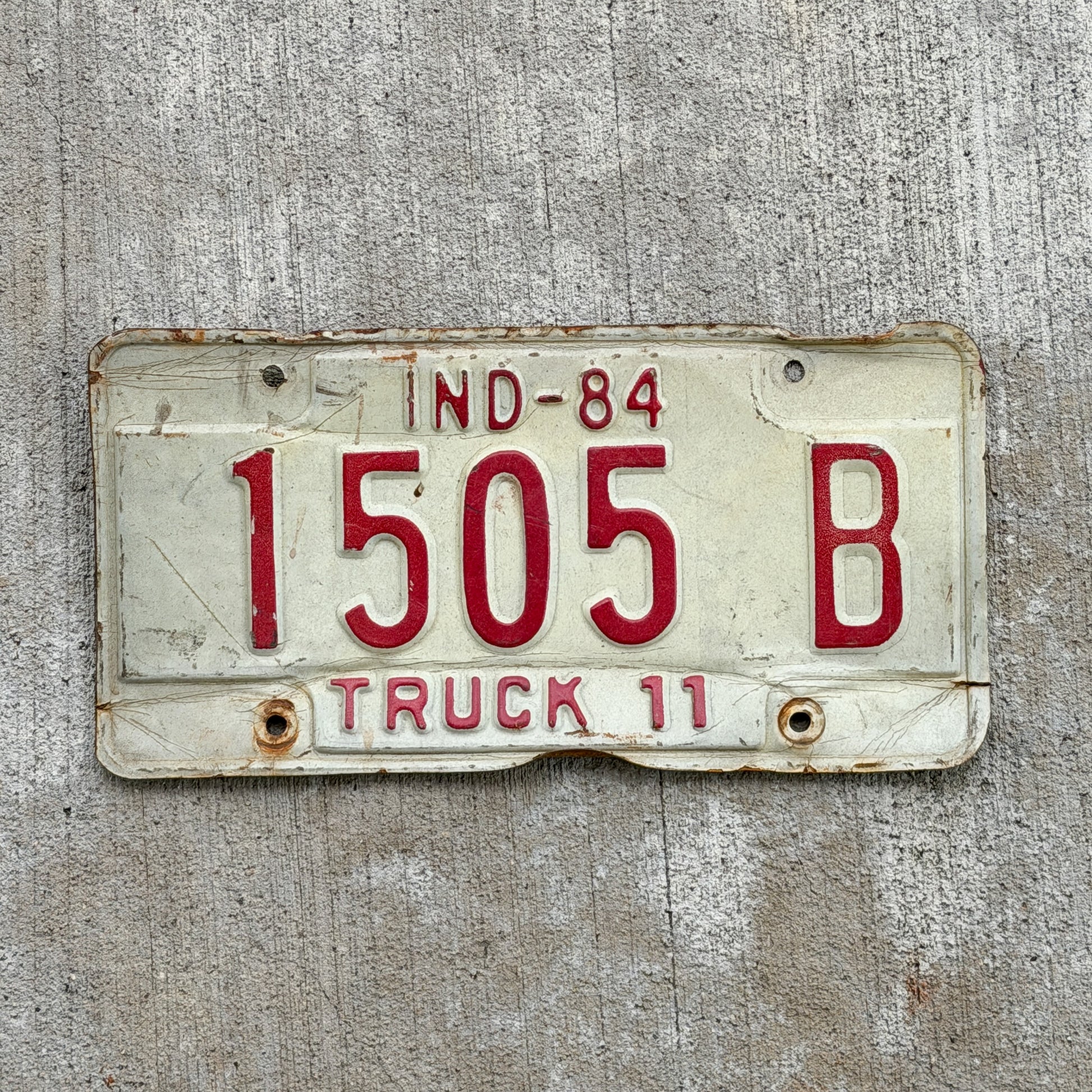 Photo of a 1984 Indiana Truck License Plate Auto Tag Garage Decor Vintage 1505 B with original patina