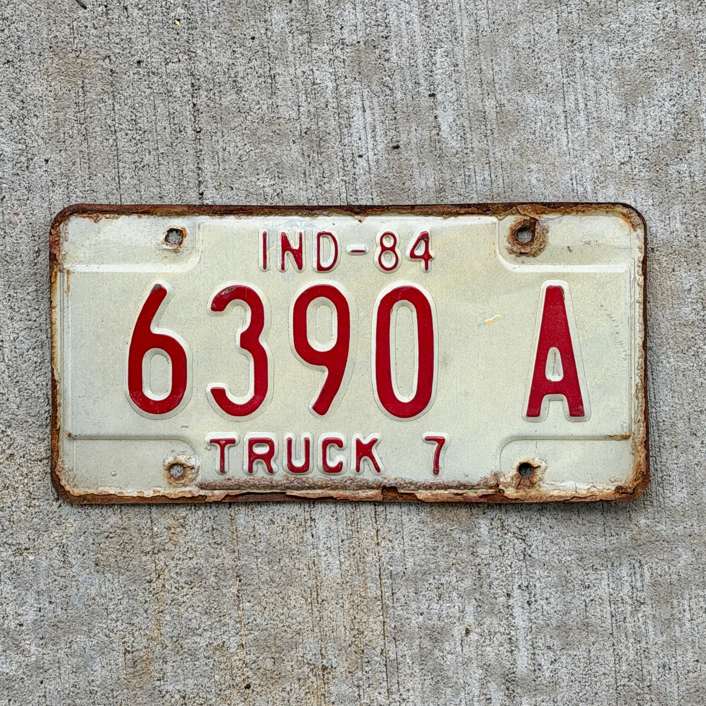 Photo of a 1984 Indiana Truck License Plate Auto Tag Garage Decor Vintage 6390 A with original patina