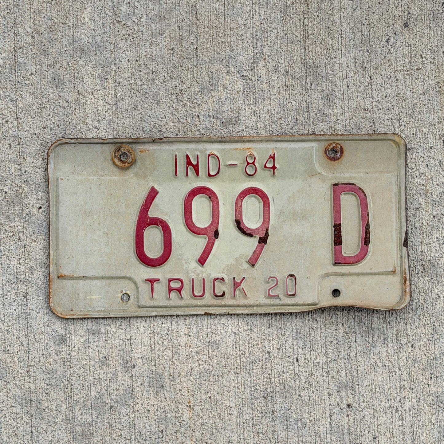 Photo of a 1984 Indiana Truck License Plate Auto Tag Garage Decor Vintage 699 D with original patina