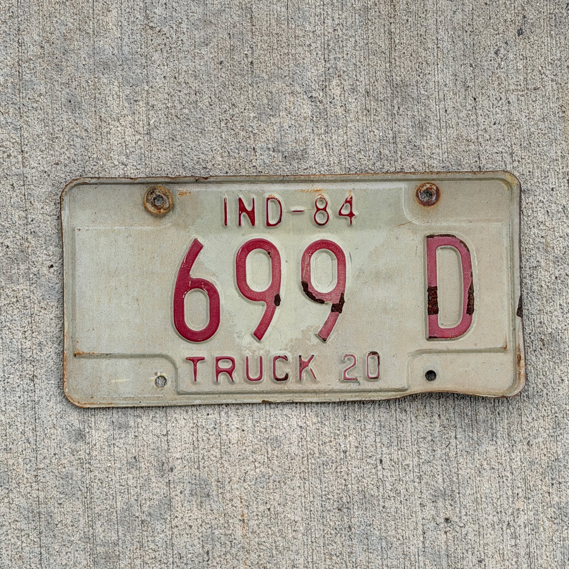 Photo of a 1984 Indiana Truck License Plate Auto Tag Garage Decor Vintage 699 D with original patina