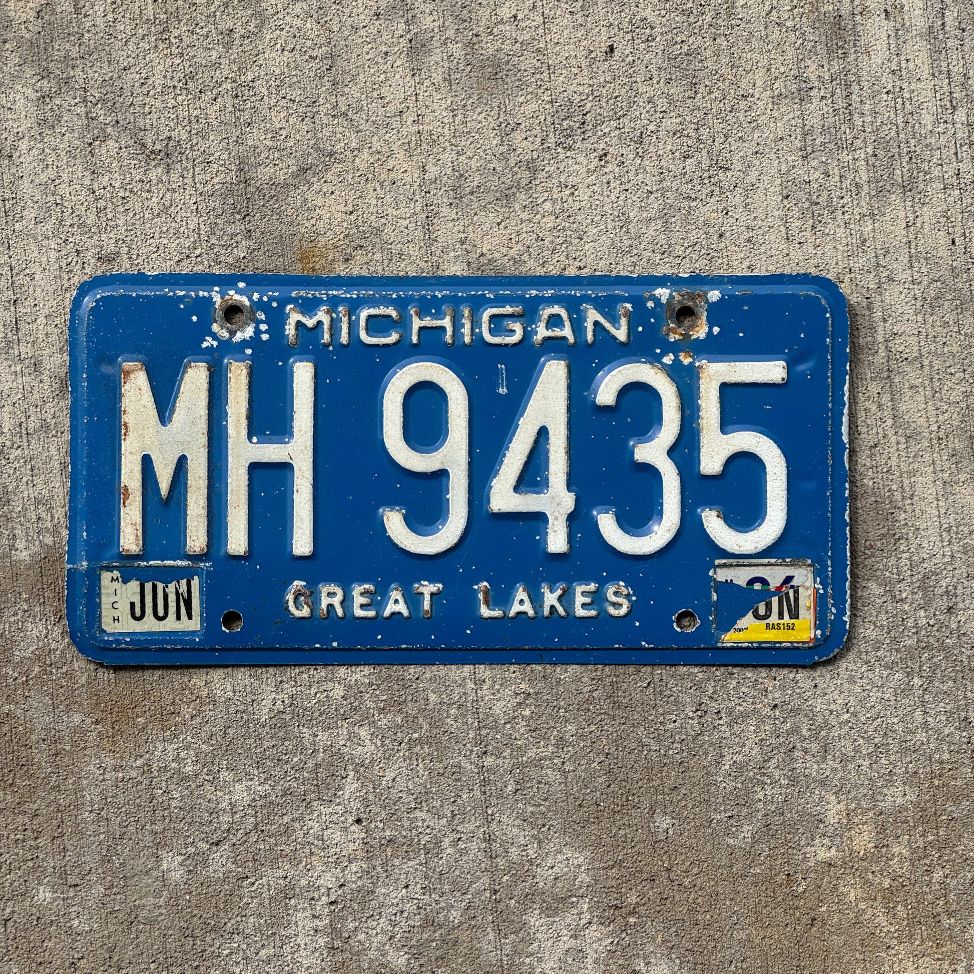 Photo of a 1984 Michigan Commercial License Plate Auto Tag Garage Decor Vintage MH 9435 with original patina