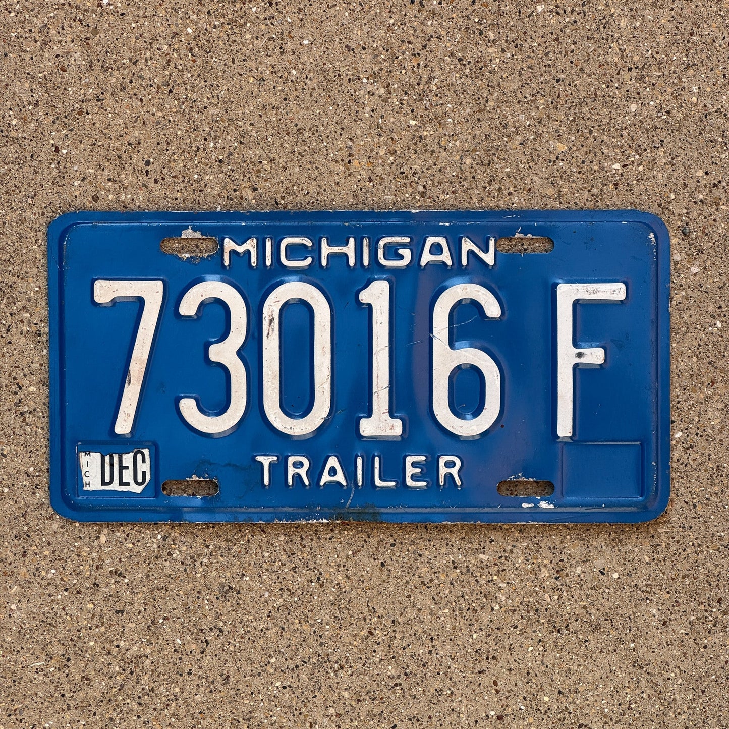 Photo of a 1984 Michigan Trailer License Plate Auto Tag Garage Decor Vintage 73016 F