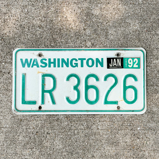 Photo of a 1984 Washington Truck License Plate Auto Tag with number LR 3626 on a concrete background that is DMV clear for road use.