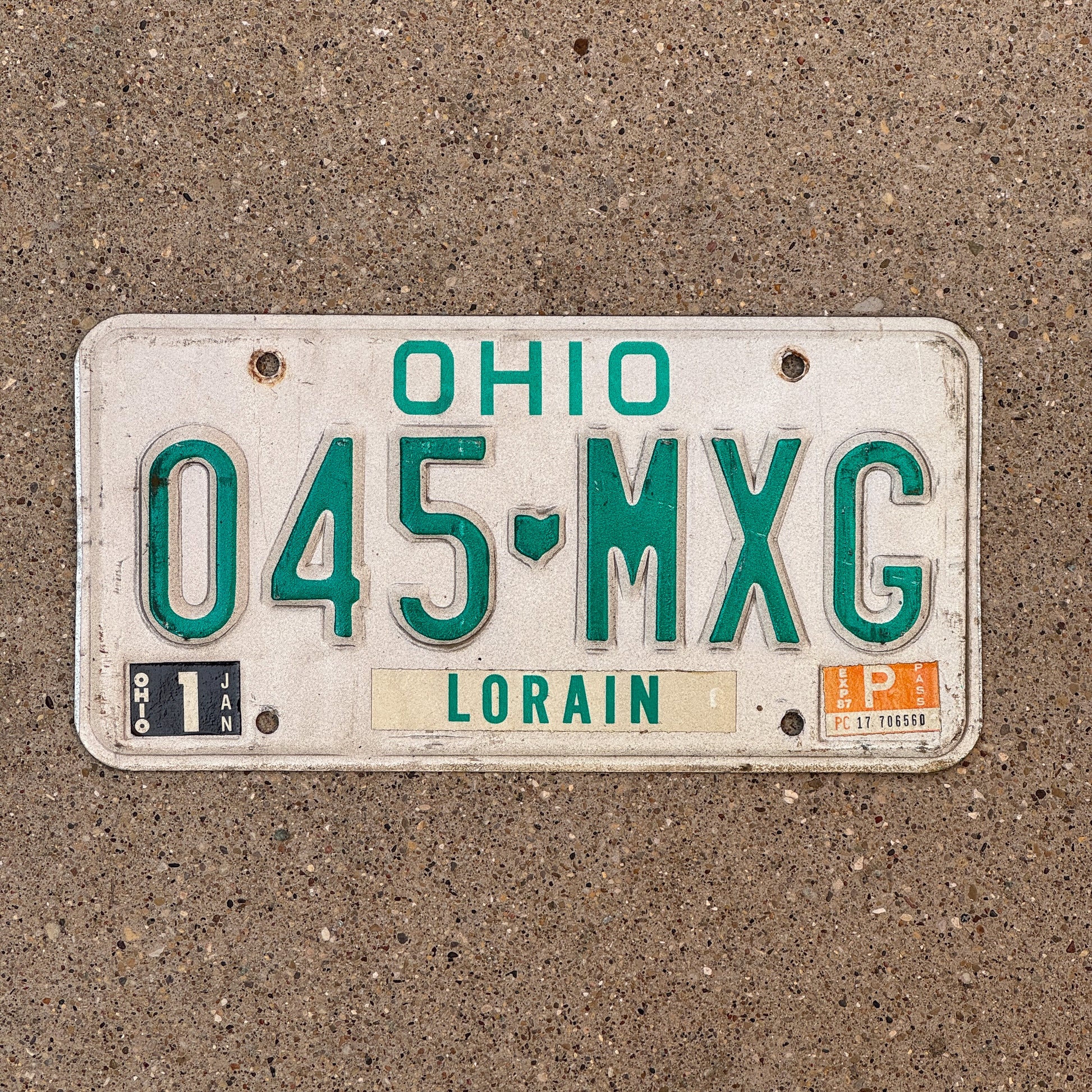 Photo of a 1985 1987 Ohio License Plate Auto Tag 1 Vintage Garage 045 MXG with original patina
