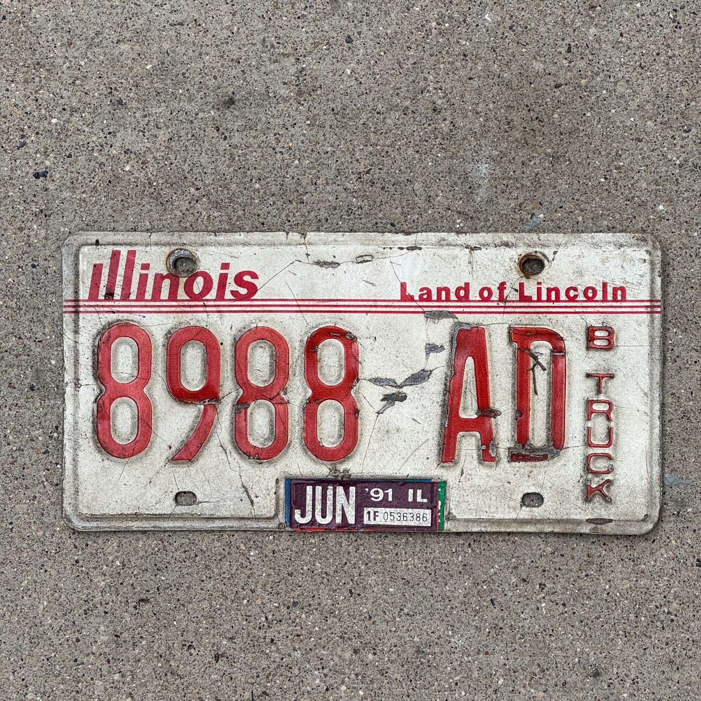 Photo of a 1985 1991 Illinois Truck License Plate Auto Tag Garage Decor Vintage 8988 AD with original patina