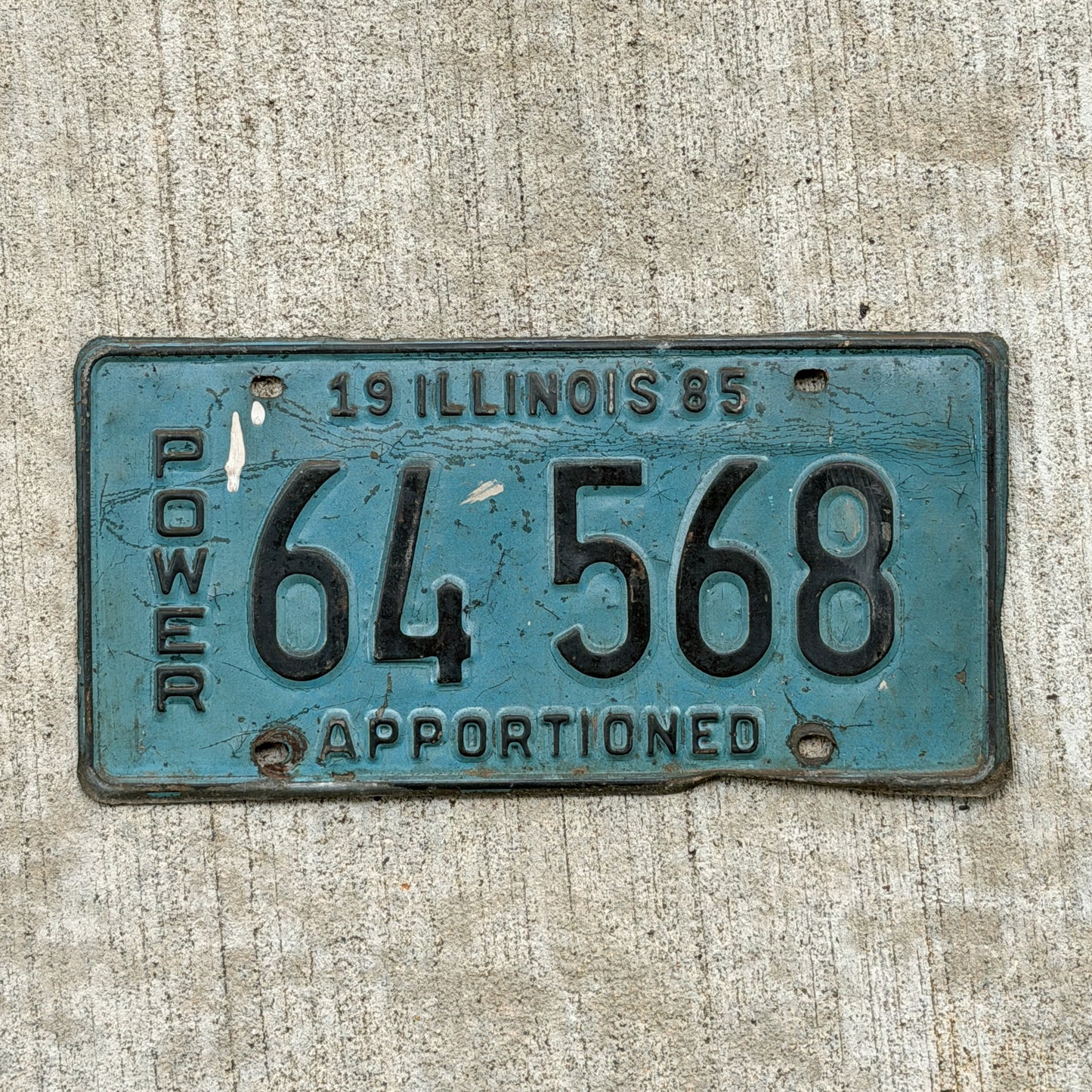 Photo of a 1985 Illinois Apportioned License Plate Auto Tag Garage Decor Vintage 64 568 with original patina
