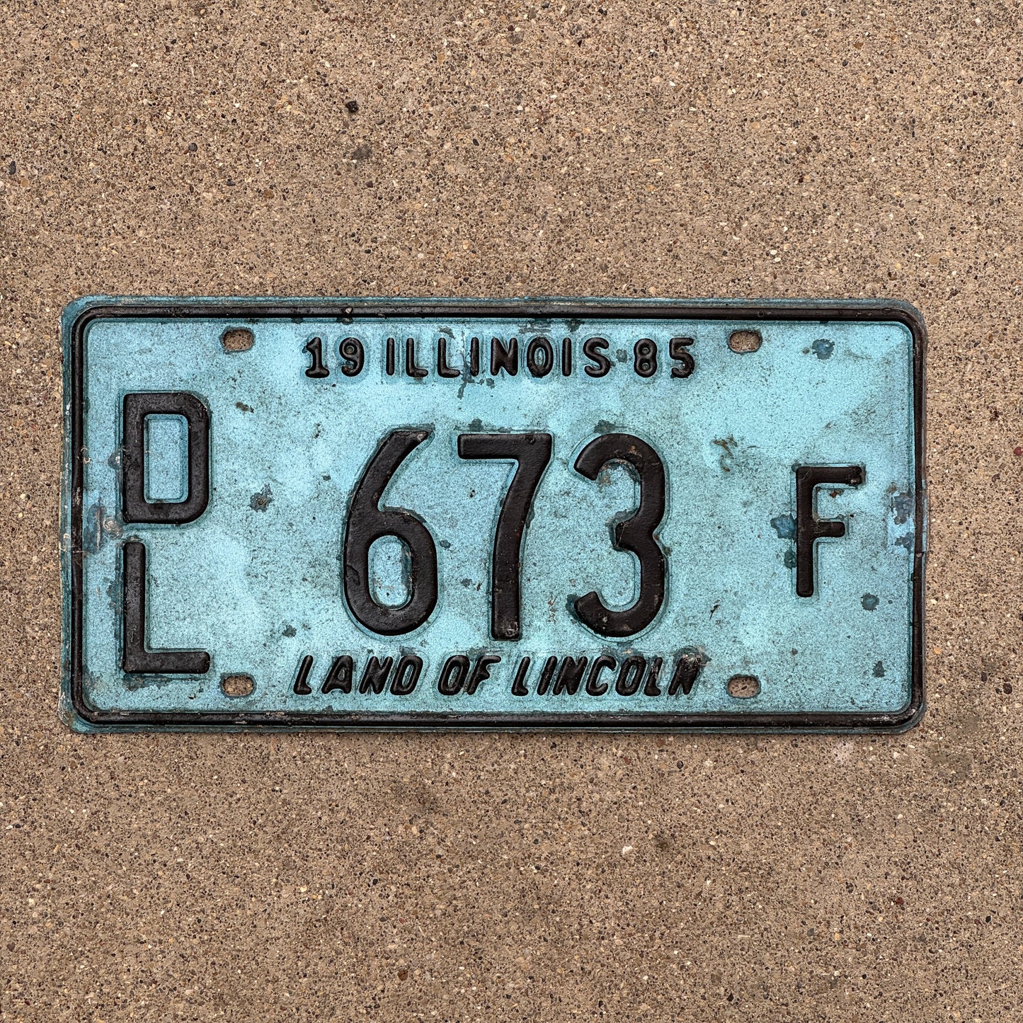 Photo of a 1985 Illinois Dealer License Plate Auto Tag 1 Vintage Garage Merritt's Sterling Ford Mercury Lincoln Dealer 673 F with original patina