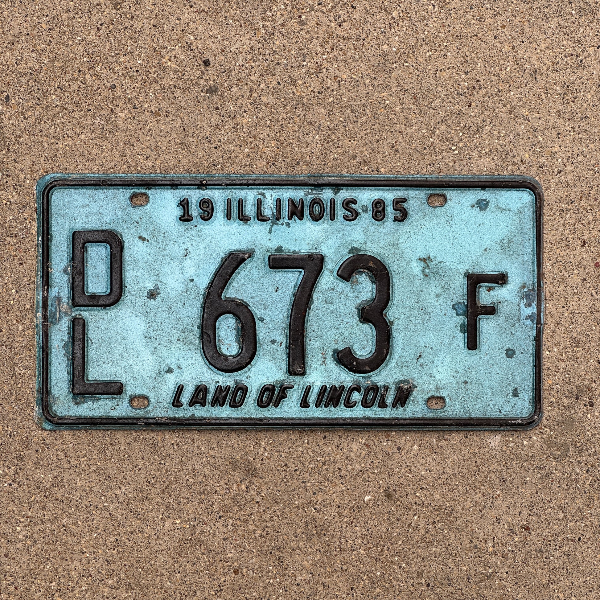 Photo of a 1985 Illinois Dealer License Plate Auto Tag 1 Vintage Garage Merritt's Sterling Ford Mercury Lincoln Dealer 673 F with original patina