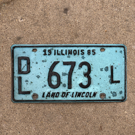 Photo of a 1985 Illinois Dealer License Plate Auto Tag 1 Vintage Garage Merritt's Sterling Ford Mercury Lincoln Dealer 673 L with original patina