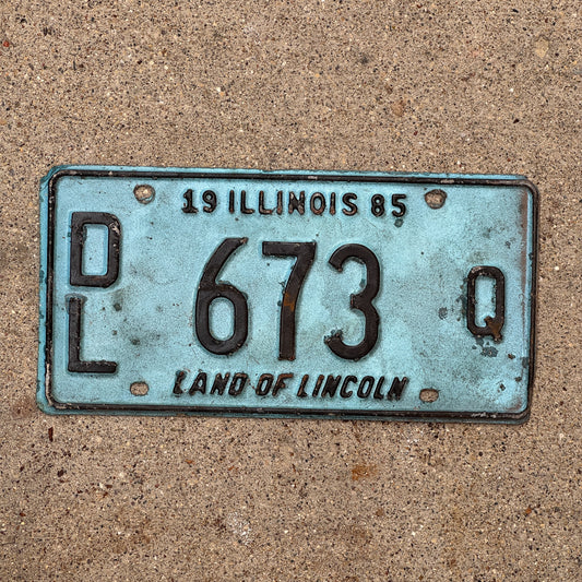 Photo of a 1985 Illinois Dealer License Plate Auto Tag 1 Vintage Garage Merritt's Sterling Ford Mercury Lincoln Dealer 673 Q with original patina