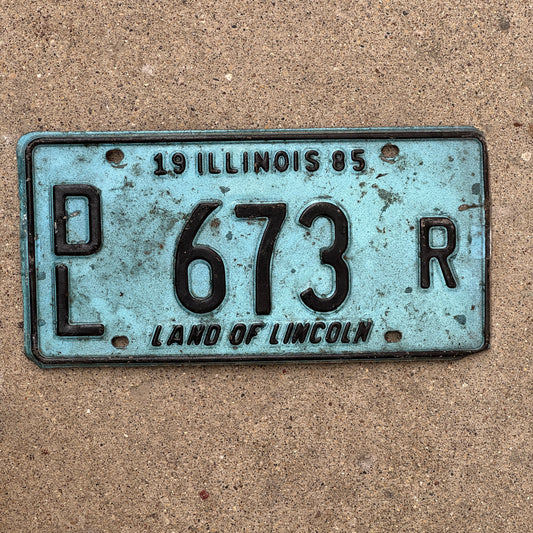 Photo of a 1985 Illinois Dealer License Plate Auto Tag 1 Vintage Garage Merritt's Sterling Ford Mercury Lincoln Dealer 673 R with original patina