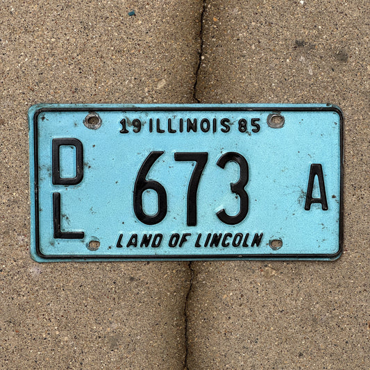 Photo of a 1985 Illinois Dealer License Plate Auto Tag 2 Vintage Garage Merritt's Sterling Ford Mercury Lincoln Dealer 673 A with original patina