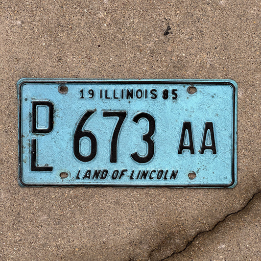 Photo of a 1985 Illinois Dealer License Plate Auto Tag 2 Vintage Garage Merritt's Sterling Ford Mercury Lincoln Dealer 673 AA with original patina